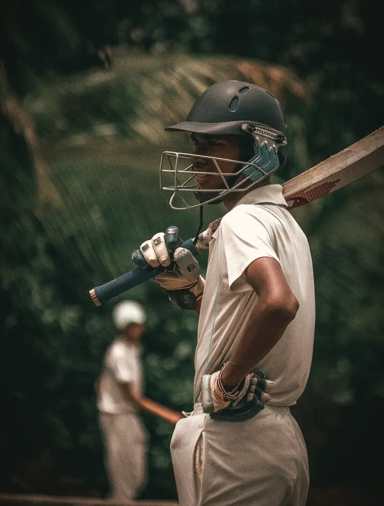 A helmeted batter between overs