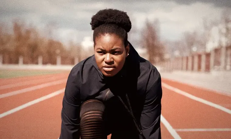 A sprinter crouched at the start line, locked in: calm focus